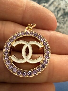 Elegant luxury C CHANEL Gold-Tone Circle Pendant with Light Purple Crystals